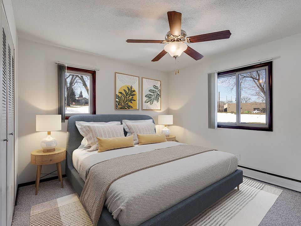 Welcome to St. Anthony Group, where modern comfort meets stylish design. This cozy bedroom features ample natural light, a ceiling fan for your comfort, and a serene atmosphere. Don't miss your chance to call this homecontact us today!