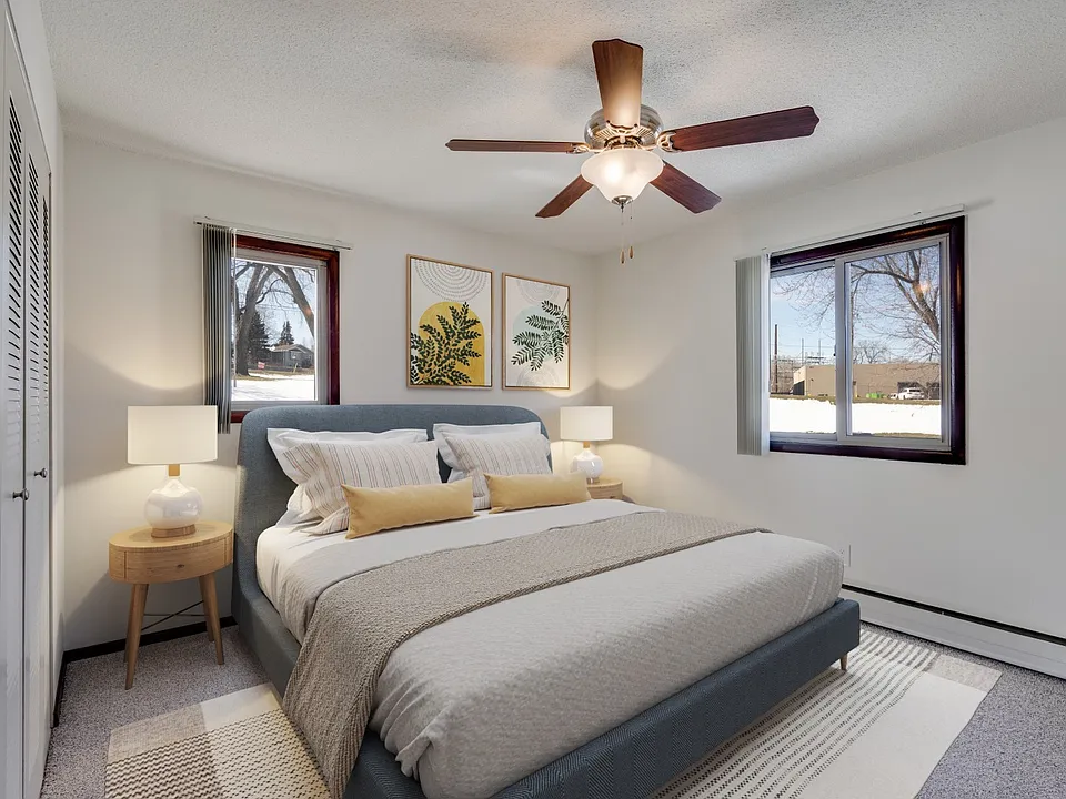 Welcome to St. Anthony Group, where modern comfort meets stylish design. This cozy bedroom features ample natural light, a ceiling fan for your comfort, and a serene atmosphere. Don't miss your chance to call this homecontact us today!