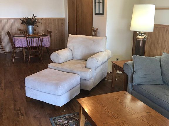 Living room conversation and tv space with view to the dining area.