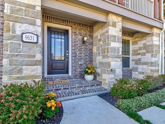 The dark wood front door with rain glass, is not only beautiful but also provides privacy while still allowing light into the en