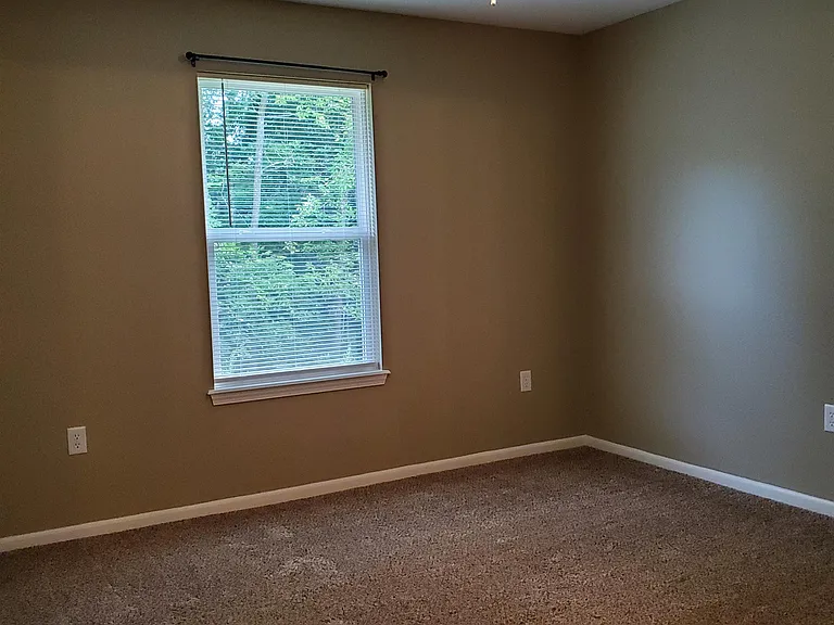 Master bedroom with ceiling fan and full bath.