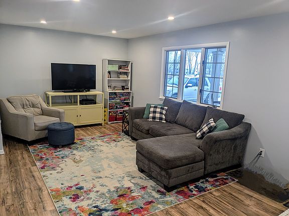 Living room with the front door entrance to the right.