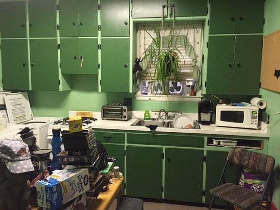 The kitchen has a double sink with disposal, gas stove, large refrigerator, washer, dryer, and lots of storage space.