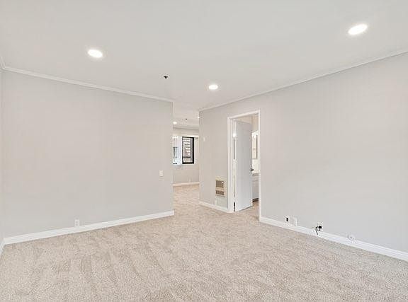 living room looking toward dinning area and door to bedroom