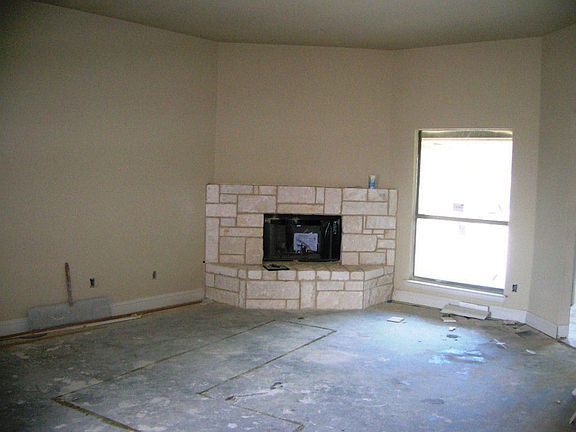 STONE, CORNER FIREPLACE IN LIVING