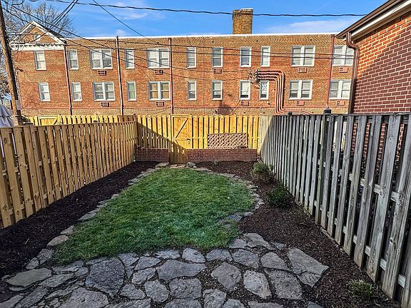 Fenced backyard with slate patio and space to garden if desired.