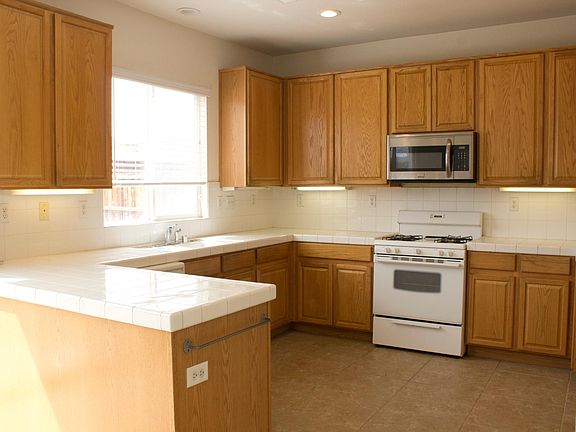 Spacious kitchen that comes with a stove, mircowave and dish