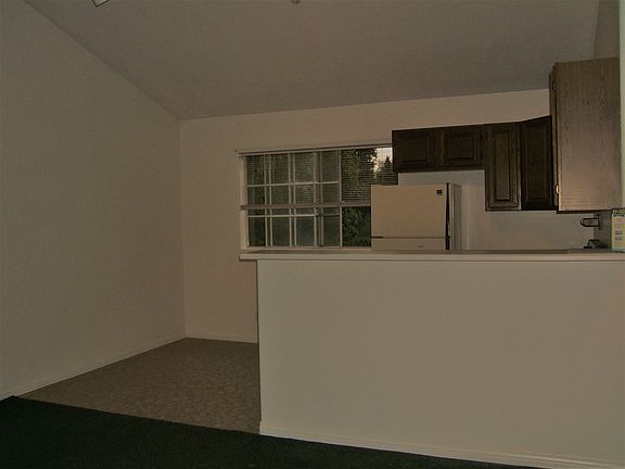 Family room looking to kitchen before new paint and carpetin