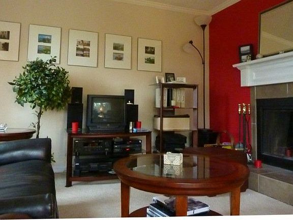 Charming living room with corner fireplace...open on 2 sides! High ceilings and large windows for lots of natural light!