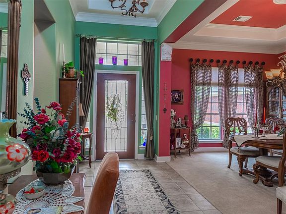 Tile floors welcome you into this lovely home which offers detailed trim work throughout. The dining room opens to the left of the entry.