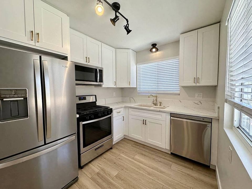 Granite Counters, Shaker Cabinetry, Stainless Appliances, Old-Fashioned Brass Faucet, Custom Light Fixtures