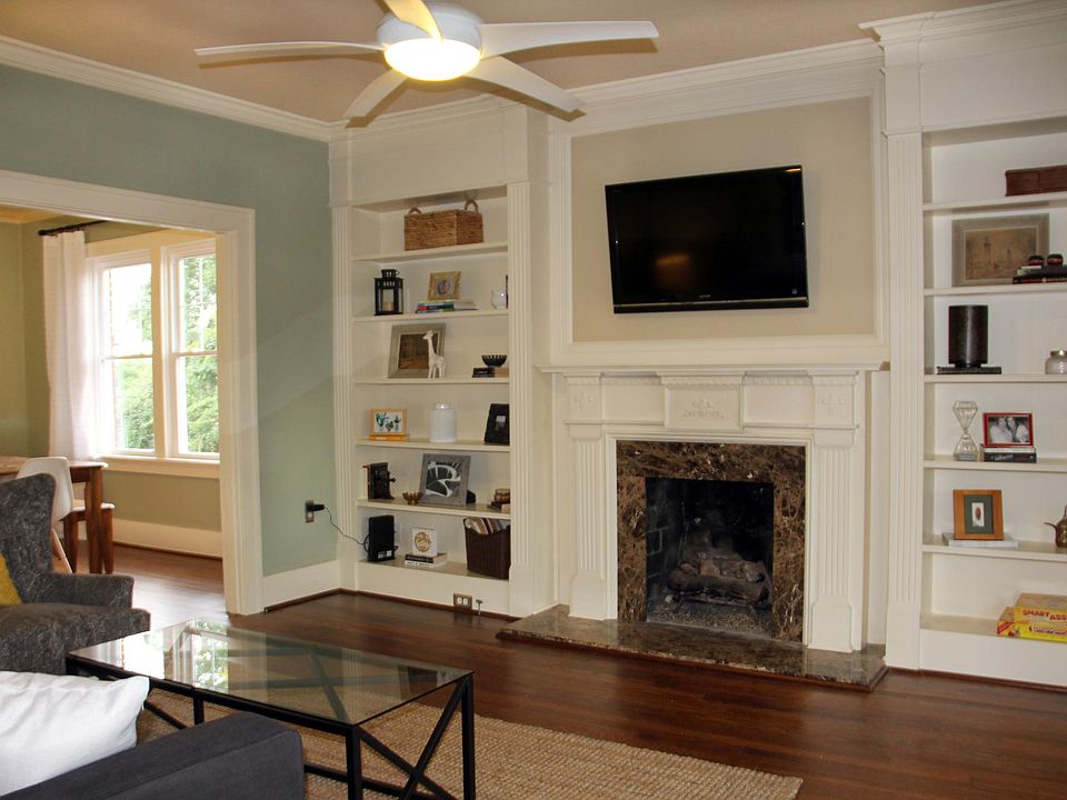 Original built-ins in living room with Smart TV with Netflix and working gas fireplace