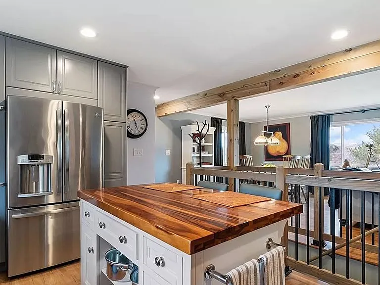 Furnished photo of island, hardwood floors, open to living area