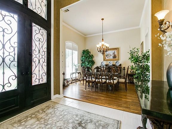 Custom Iron Doors, Stunning hardwoods, Plantation Shutters, 12 ft. Ceilings all make a fabulous impression!