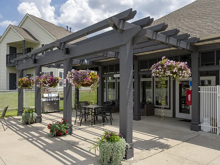 Relax and unwind in a beautifully landscaped patio, perfect for enjoying fresh air and community gatherings.
