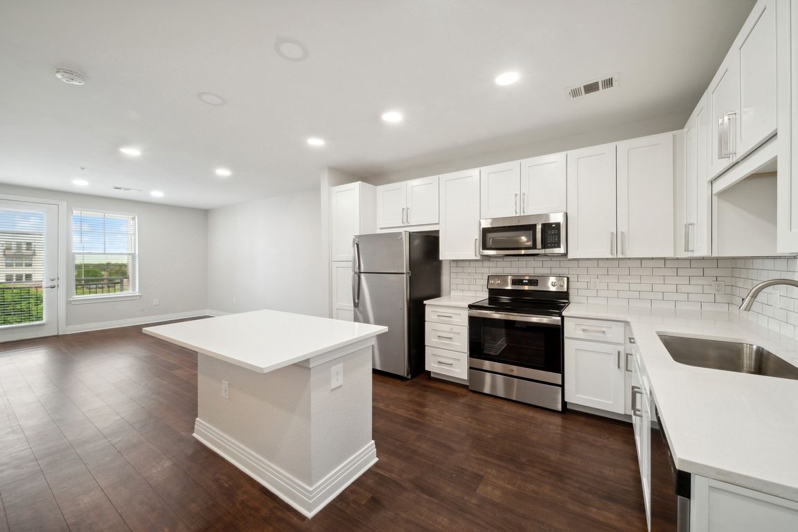 New kitchens with stainless steel appliances and white quartz countertops