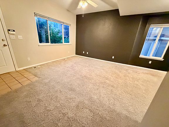 Another view of main level living room showing front door access.