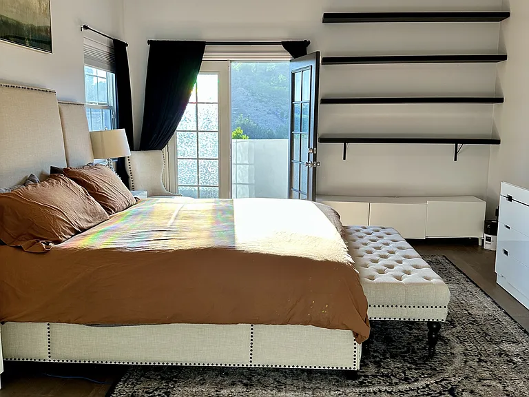 Main bedroom with french doors to private balcony