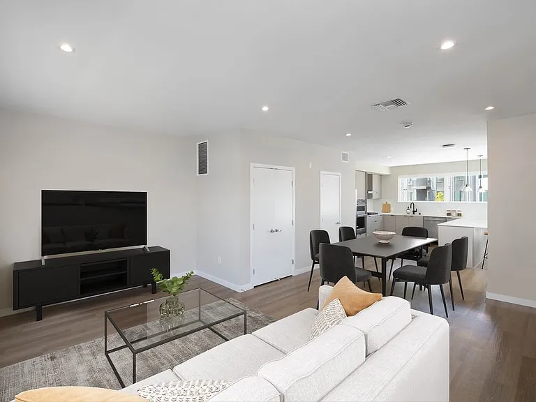 Signature Collection I 4-Bedroom Townhome Living and dining areas with hard-surface vinyl plank flooring throughout