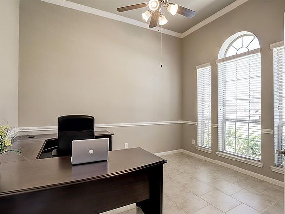 The study boasts a wall of windows, is quite large and has gorgeous french doors.