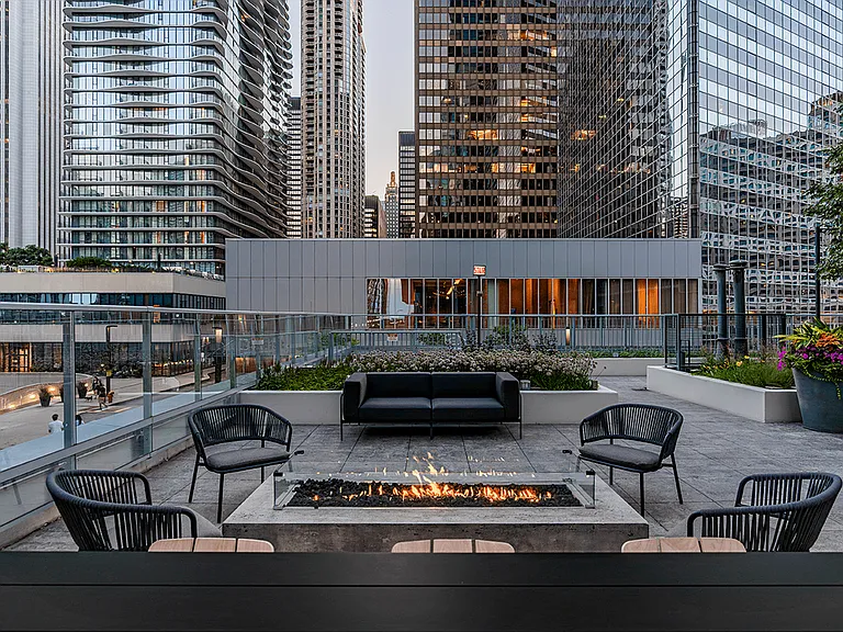 Relax in our outdoor lounge with cozy seating, a fire pit, and skyline views