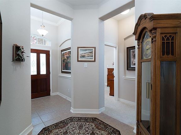 Architectural details include arched windows, art niches, crown molding and cozy rotunda area!