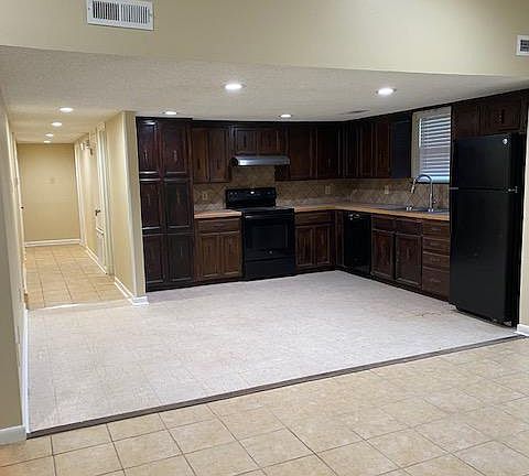 View into open, eat-in kitchen from family room.