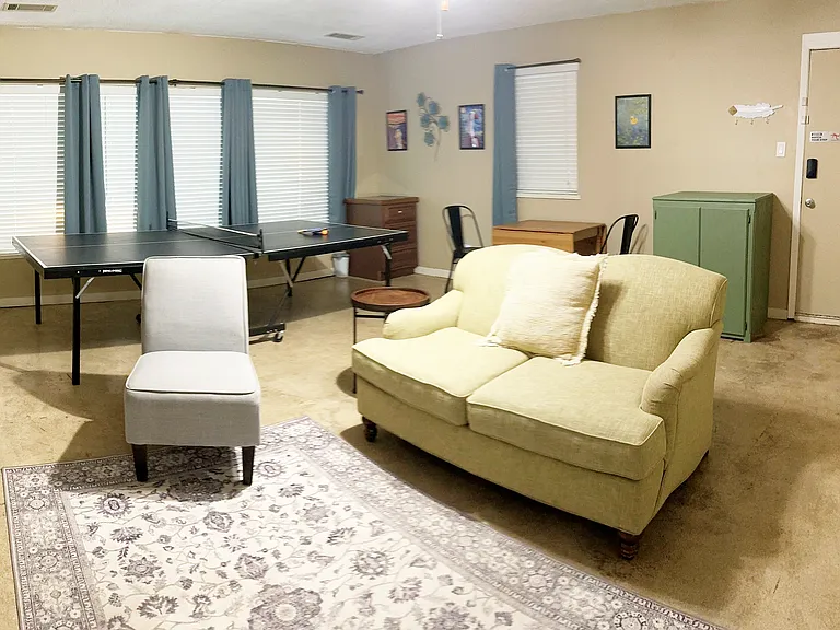 Game room with ping pong table, games, books, and TV