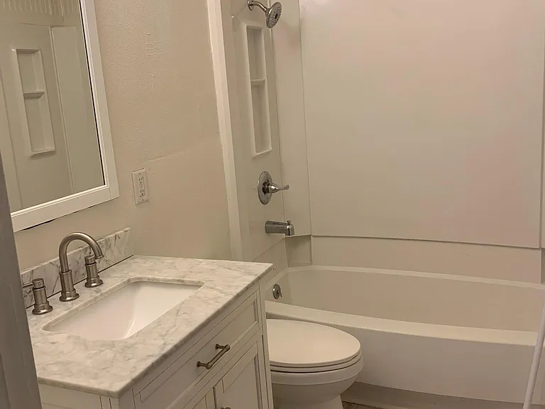 This bath has vinyl plank flooring and serves the two bedrooms.