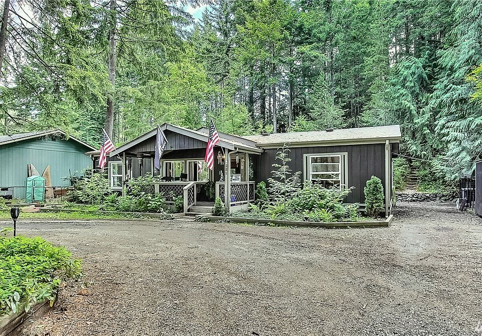Front view of home, note circular drive in front, nice covered front porch and shed on right. 