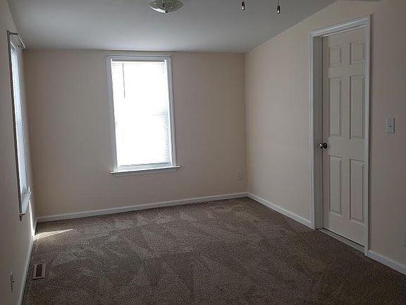 Primary Bedroom w/ closet and access to bathroom and kitchen