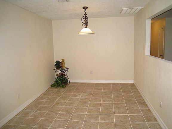Dining room with new chandelier, tile floor and fresh paint