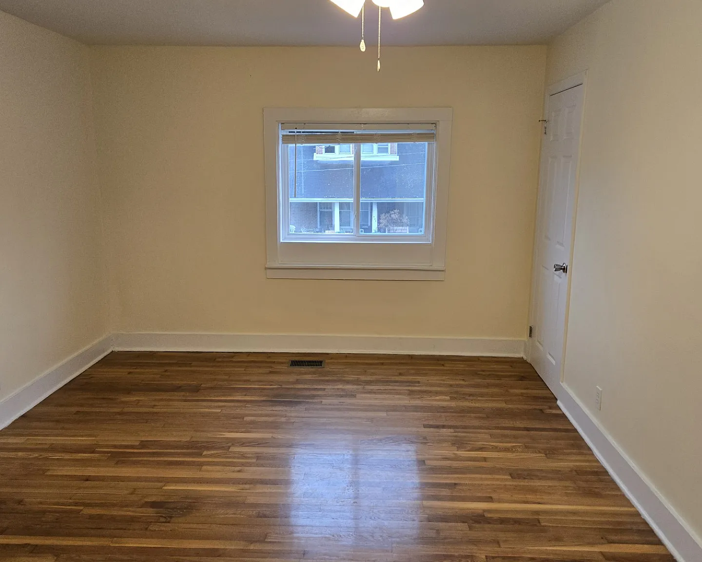 Livingroom, with ceiling fan, window view of the street.