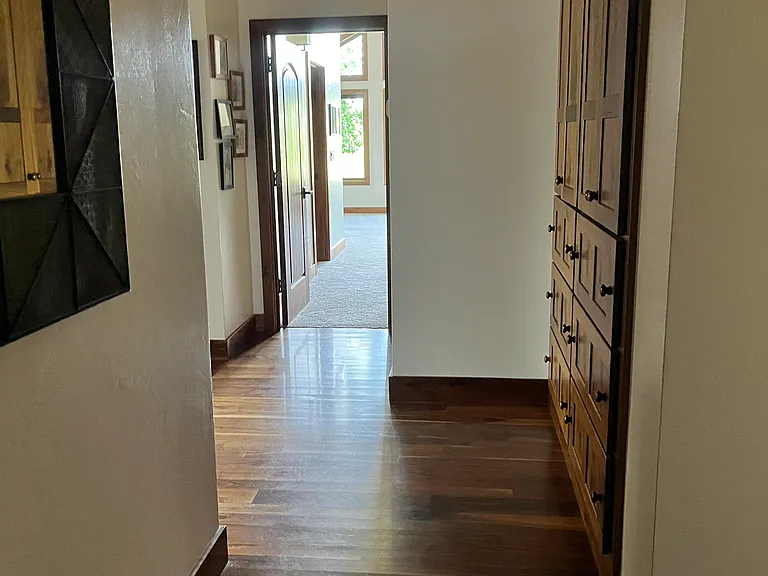 Hallway to bedrooms with built in cabinets.