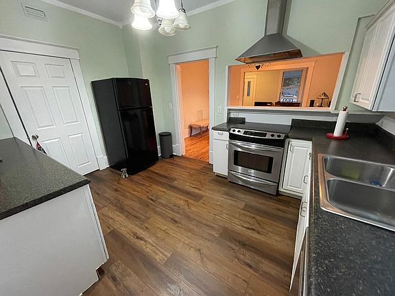 Kitchen looking through serving window to dining room.