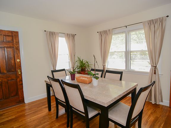 Dining Room with front and side facing window. Wooden side door opens to the new deck.