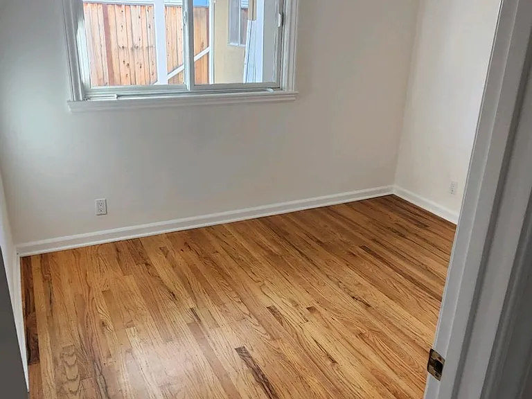 Bedroom #2 freshly painted with hardwood floors