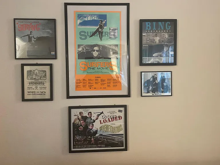 The home is decked out with retro surf poster collection_many of which are signed
