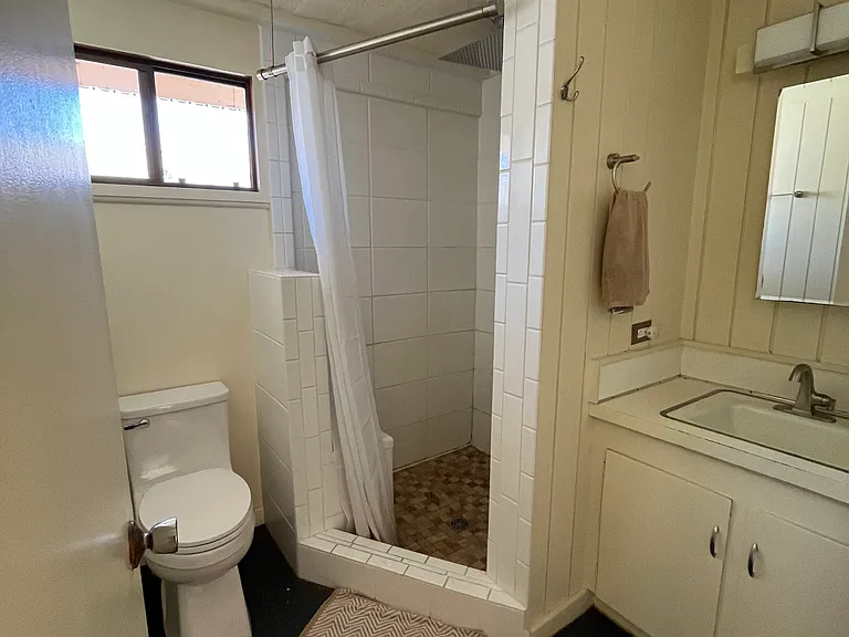 Main bathroom. Shower features regular showerhead and rain showerhead. Plenty of hot water from solar water heater with electric back up.
