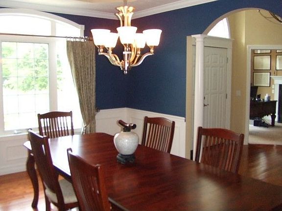 The formal dining room has trey ceiling, gleaming wood floors
