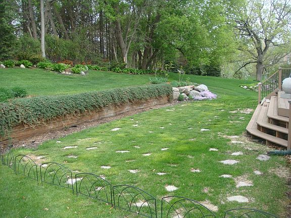 Large backyard with a private deck with space for grilling and outdoor furniture.