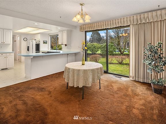 Another view of the kitchen that includes the dining area.