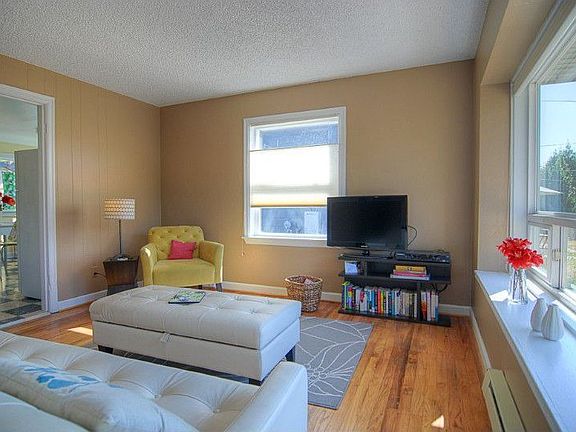 Living Room is light & bright and features refinished hardwoods & double-paned windows