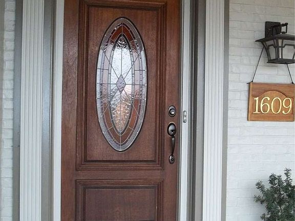 "Custom stain glass door accents the entrance."