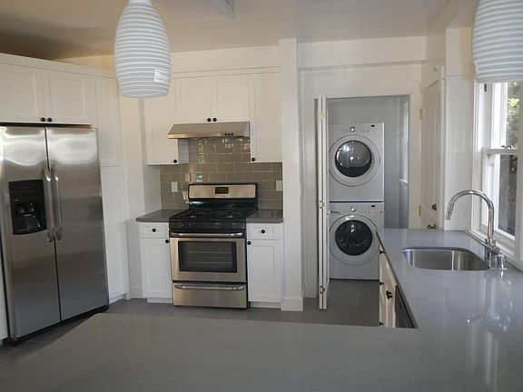Spacious, updated kitchen with gas range, newer appliances, and in-unit laundry just off the kitchen