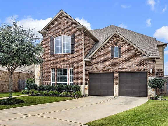 Notice the handsome builder details on this home including the brick accented, arched, shuttered windows. The wide driveway leading to the two car garage offers plenty of off street parking for homeowners and guests.