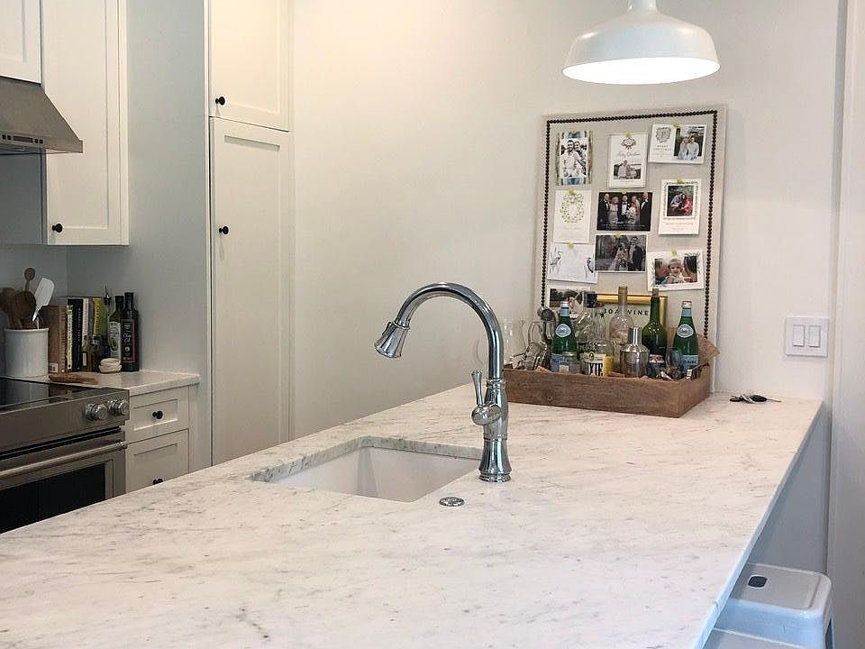 Kitchen has marble counters and stainless appliances.
