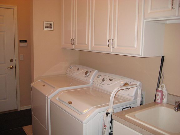 Laundry room with extra cabinets and vanity