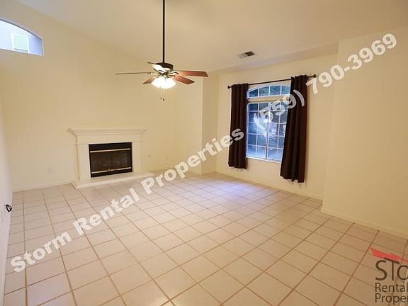 Living room with gas fireplace and fan