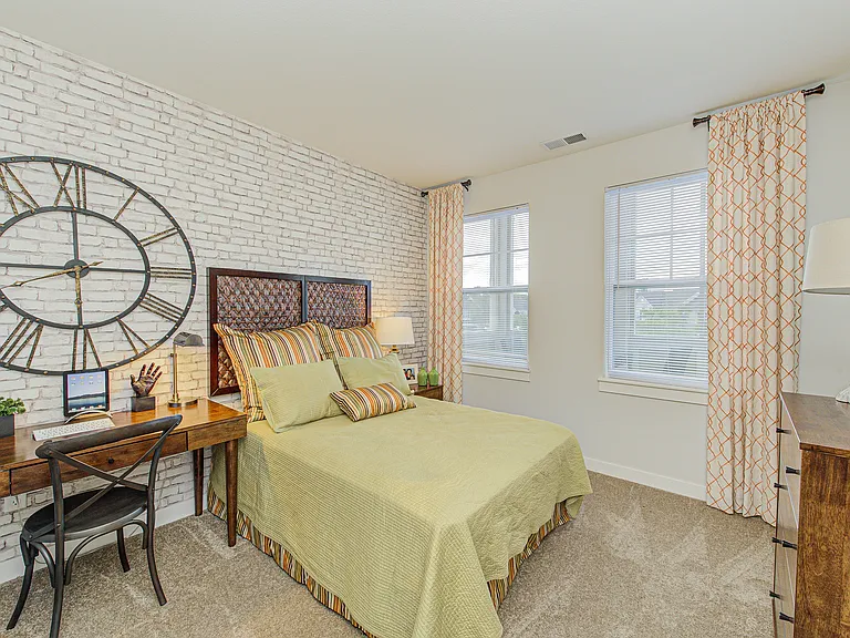 Bright and roomy, this bedroom offers space to relax, recharge, and make your own _ shown here with sample furniture for scale.